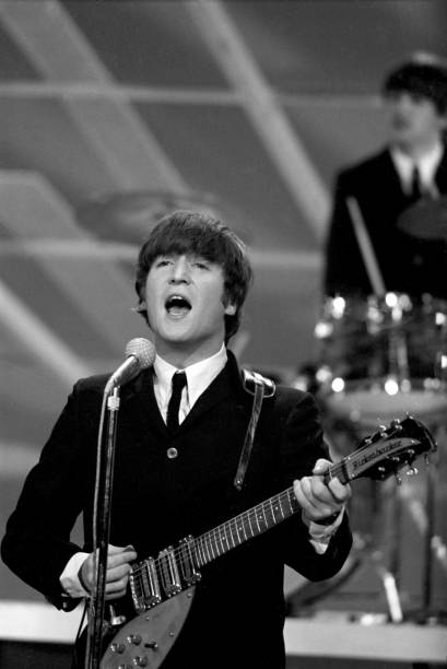 NEW YORK CITY - FEBRUARY 9: English singer, songwriter and guitarist John Lennon (1940-1980) and English drummer Ringo Starr perform on "The Ed Sullivan Show" during The Beatles' American debut in New York City on February 9, 1964. (Photo by Jeff Hochberg/Getty Images)